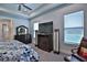 Main bedroom with dark wood furniture and a large television is bathed in bright, natural light at 5845 Sw 43Rd Street Rd, Ocala, FL 34474