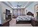 A cozy main bedroom features a tray ceiling, neutral color palette and dark wood furniture set at 5845 Sw 43Rd Street Rd, Ocala, FL 34474