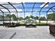 Expansive screened patio with dining, lounge, and egg chairs, designed for ultimate outdoor enjoyment at 5845 Sw 43Rd Street Rd, Ocala, FL 34474