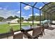 Inviting screened patio with comfortable seating and dining, overlooking a well-manicured lawn at 5845 Sw 43Rd Street Rd, Ocala, FL 34474