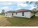 View of the house from the backyard featuring a covered patio and ample yard space at 6240 Cherry Rd, Ocala, FL 34472