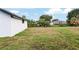Spacious backyard showing plenty of green and an adjacent home at 6240 Cherry Rd, Ocala, FL 34472