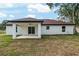 The backyard features a covered patio with a ceiling fan and provides outdoor living space at 6240 Cherry Rd, Ocala, FL 34472