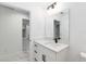 Bright bathroom featuring modern vanity, marble floors, and sleek black fixtures at 6240 Cherry Rd, Ocala, FL 34472
