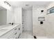 A spacious bathroom boasts a dual sink vanity with modern fixtures and a glass-enclosed shower with custom tiling at 6240 Cherry Rd, Ocala, FL 34472