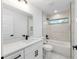 Modern bathroom with tile surround tub, marble floors, and black fixtures at 6240 Cherry Rd, Ocala, FL 34472