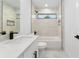 Modern bathroom featuring marble tiling, black fixtures, and an abundance of natural light at 6240 Cherry Rd, Ocala, FL 34472