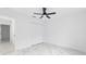 Well-lit bedroom featuring a ceiling fan, large closet, and marble floors at 6240 Cherry Rd, Ocala, FL 34472