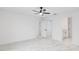 Open bedroom featuring marble floors, bright white walls, and an open closet at 6240 Cherry Rd, Ocala, FL 34472