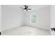 Simple bedroom featuring a ceiling fan, marble floors, and a window at 6240 Cherry Rd, Ocala, FL 34472