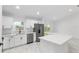 Open-concept kitchen with white cabinets, stainless steel appliances, and a spacious island at 6240 Cherry Rd, Ocala, FL 34472