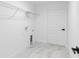 Clean, well-lit laundry room featuring white walls and modern white tile at 6240 Cherry Rd, Ocala, FL 34472