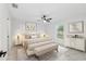 Comfortable main bedroom featuring a bed, bench, paintings, and marble floors at 6240 Cherry Rd, Ocala, FL 34472