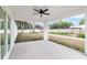 This covered patio features a ceiling fan and a view of the fenced in backyard and landscaping at 6240 Cherry Rd, Ocala, FL 34472