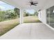 Covered patio features concrete flooring, sleek ceiling fan, and views of the surrounding backyard and landscaping at 6240 Cherry Rd, Ocala, FL 34472