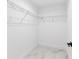 Bright walk-in closet with wire shelving and clean, marble-patterned flooring for optimal storage and style at 6240 Cherry Rd, Ocala, FL 34472