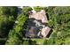 Expansive home with a screened-in pool, nestled amongst mature trees offering privacy and a tranquil setting at 695 Se 47Th Loop, Ocala, FL 34480