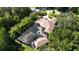 Expansive property with a screened-in pool, nestled amongst mature trees offering privacy and a tranquil setting at 695 Se 47Th Loop, Ocala, FL 34480