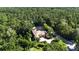 Lush landscaping surrounds this private estate, offering a serene retreat with mature trees and manicured lawns at 695 Se 47Th Loop, Ocala, FL 34480