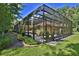 Picture of backyard with gravel path, manicured lawn, and screened-in pool at 695 Se 47Th Loop, Ocala, FL 34480
