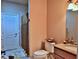 Cozy bathroom features a granite countertop vanity, toilet, and a shower with a decorative curtain at 695 Se 47Th Loop, Ocala, FL 34480