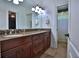 Bathroom with double vanity, granite countertop, and tile flooring at 695 Se 47Th Loop, Ocala, FL 34480