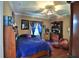 Comfortable bedroom with ceiling fan, blue bedding, and decorative accents at 695 Se 47Th Loop, Ocala, FL 34480
