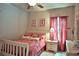 Inviting bedroom features comfortable bedding, natural light, and tasteful decor for a restful night's sleep at 695 Se 47Th Loop, Ocala, FL 34480