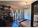 Cozy bedroom features hardwood floors, shelves, chandelier and large windows at 695 Se 47Th Loop, Ocala, FL 34480