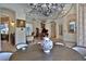 Elegant dining area showcasing modern chandeliers, grand piano and natural light at 695 Se 47Th Loop, Ocala, FL 34480