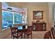 This dining area offers natural light from a large bay window offering views of the pool, plus a decorative chandelier at 695 Se 47Th Loop, Ocala, FL 34480
