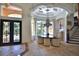 Elegant dining area featuring a modern chandelier, neutral palette, and natural light at 695 Se 47Th Loop, Ocala, FL 34480