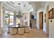 Elegant dining area featuring a modern chandelier, neutral palette, and natural light at 695 Se 47Th Loop, Ocala, FL 34480