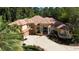 Stunning home showcasing meticulously manicured landscaping and beautiful architectural details, including a terracotta roof at 695 Se 47Th Loop, Ocala, FL 34480