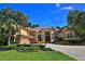 Charming residence showcasing a circular driveway, a basketball hoop, and colorful garden beds at 695 Se 47Th Loop, Ocala, FL 34480