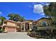 Elegant home featuring a tile roof, a two-car garage, and meticulously maintained flower beds at 695 Se 47Th Loop, Ocala, FL 34480