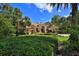 Beautiful home with mature landscaping, palm trees, and a well-manicured lawn at 695 Se 47Th Loop, Ocala, FL 34480