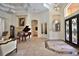 Elegant foyer with grand piano, fireplace and marble floors at 695 Se 47Th Loop, Ocala, FL 34480
