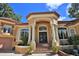 Grand front entrance showcasing a covered porch, a set of stairs, and professionally landscaped planters at 695 Se 47Th Loop, Ocala, FL 34480