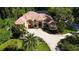 Stately home with mature landscaping, a circular driveway, and elegant architectural features at 695 Se 47Th Loop, Ocala, FL 34480