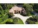 Stately home with lush landscaping, a circular driveway, and charming architectural details at 695 Se 47Th Loop, Ocala, FL 34480