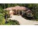 Grand home with lush landscaping, a circular driveway, and an inviting entrance at 695 Se 47Th Loop, Ocala, FL 34480