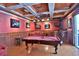 This game room features a pool table, comfortable seating, custom ceiling design, and a bar area for entertainment at 695 Se 47Th Loop, Ocala, FL 34480