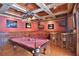 This game room features a pool table, comfortable seating, custom ceiling design, and a bar area for entertainment at 695 Se 47Th Loop, Ocala, FL 34480