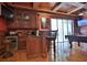This game room with hardwood floors features a wet bar and access to the outdoor entertaining areas at 695 Se 47Th Loop, Ocala, FL 34480