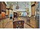 A spacious kitchen features custom cabinetry, granite countertops, stainless steel appliances, and a central island with storage at 695 Se 47Th Loop, Ocala, FL 34480