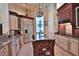 Gourmet kitchen with stainless steel appliances, custom cabinetry, granite countertops, and large island at 695 Se 47Th Loop, Ocala, FL 34480