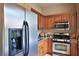 Modern kitchen featuring stainless steel appliances, granite countertops, and ample cabinet space for cooking and storage at 695 Se 47Th Loop, Ocala, FL 34480