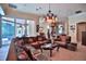 Expansive living room with a large sectional sofa, elegant decor, and seamless access to an outdoor pool area at 695 Se 47Th Loop, Ocala, FL 34480