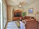 Comfortable living room features natural light, a ceiling fan, a TV, and a plush sofa for relaxation at 695 Se 47Th Loop, Ocala, FL 34480